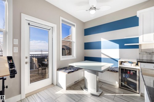 Dining space featuring beverage cooler, a ceiling fan, and a water view - 81 Richmond Link, Fort Saskatchewan, AB - Indoor Photo Showing Other Room