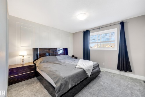 Bedroom with baseboards and light carpet - 81 Richmond Link, Fort Saskatchewan, AB - Indoor Photo Showing Bedroom