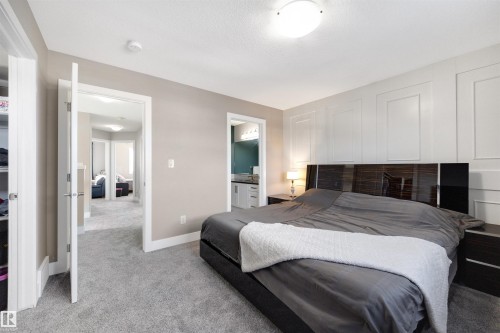 Bedroom with light colored carpet and ensuite bathroom - 81 Richmond Link, Fort Saskatchewan, AB - Indoor Photo Showing Bedroom