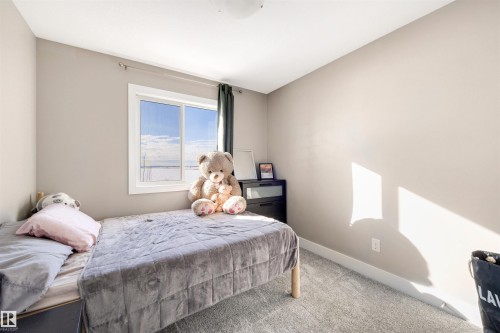 Carpeted bedroom featuring baseboards - 81 Richmond Link, Fort Saskatchewan, AB - Indoor Photo Showing Bedroom