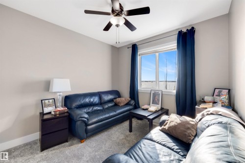 Carpeted living room with ceiling fan and baseboards - 81 Richmond Link, Fort Saskatchewan, AB - Indoor Photo Showing Living Room