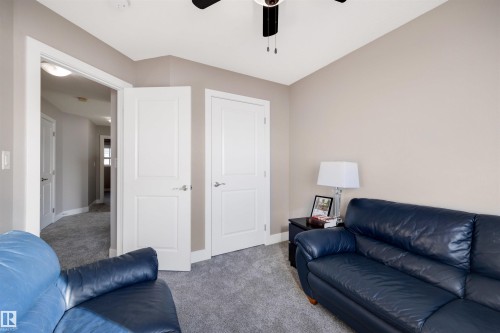 Carpeted living room featuring baseboards and a ceiling fan - 81 Richmond Link, Fort Saskatchewan, AB - Indoor Photo Showing Living Room