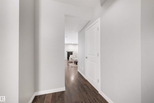 Hall with a drop ceiling and dark wood-type flooring - 81 Richmond Link, Fort Saskatchewan, AB - Indoor Photo Showing Other Room