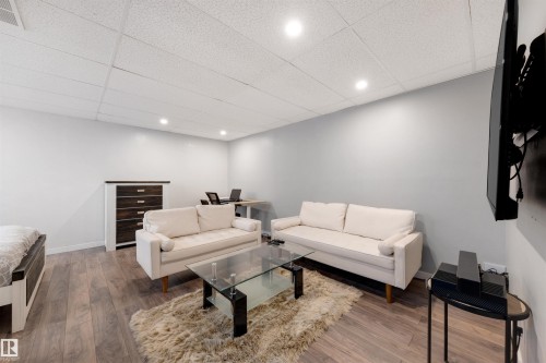 Living area featuring a paneled ceiling, wood finished floors, and recessed lighting - 81 Richmond Link, Fort Saskatchewan, AB - Indoor
