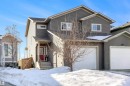 View of front of house with an attached garage, a gate, and a shingled roof - 81 Richmond Link, Fort Saskatchewan, AB  - Outdoor With Facade 