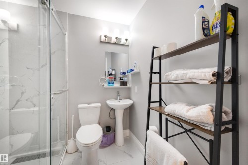 Full bathroom featuring light marble finish flooring and a marble finish shower - 81 Richmond Link, Fort Saskatchewan, AB - Indoor Photo Showing Bathroom