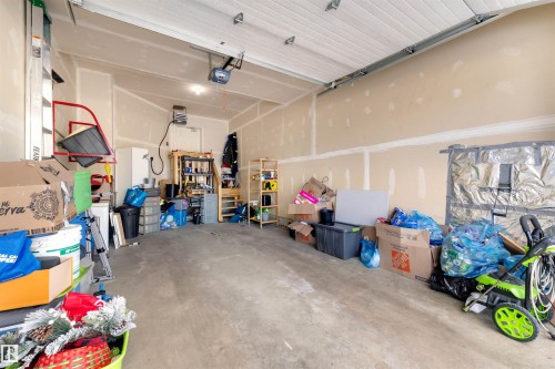 Garage with a garage door opener and a heating unit - 81 Richmond Link, Fort Saskatchewan, AB - Indoor Photo Showing Garage