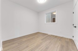 Spare room featuring light wood-style floors and baseboards - 