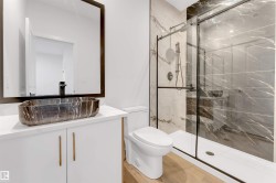 Bathroom with vanity and a marble finish shower - 