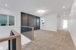 Empty room with recessed lighting and light colored carpet - 