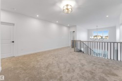 Unfurnished room featuring a chandelier, recessed lighting, and light carpet - 