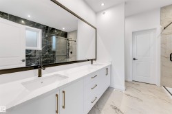 Full bathroom with light marble finish flooring, a marble finish shower, double vanity, and recessed lighting - 