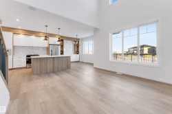 Kitchen with white cabinetry, hanging light fixtures, a center island, modern cabinets, and stove - 