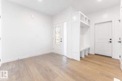 Mudroom with light wood-style flooring and baseboards - 