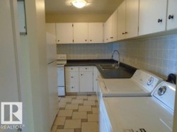 Laundry area featuring light flooring and washing machine and dryer - 