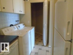 Laundry area featuring light flooring, cabinet space, and washer and dryer - 