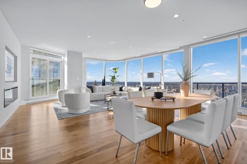 Dining space featuring light wood-style flooring, expansive windows, and recessed lighting - 4704 10360 102 Street, Edmonton, AB 