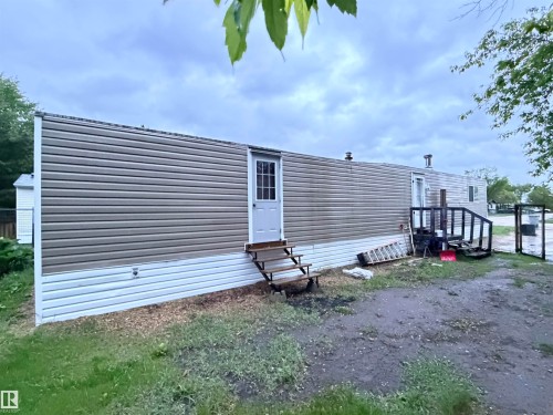 Exterior featuring horizontal siding and white trim - 68 9501 104 Avenue, Westlock, AB 