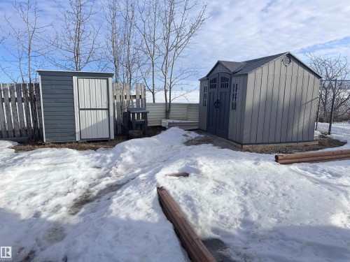 Two storage sheds featuring durable siding and pitched roofs - 68 9501 104 Avenue, Westlock, AB 