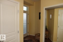 Entrance foyer with dark laminate flooring and baseboards - 