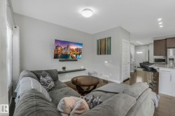 Living room with wood finished floors and recessed lighting - 