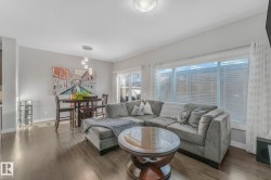 Living room featuring hardwood / wood-style flooring and baseboards - 