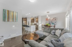 Living room featuring dark wood finished floors and recessed lighting - 