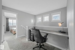 Office space with light carpet and baseboards - 