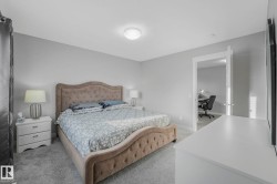 Bedroom with an office area and light carpet - 