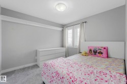 Bedroom featuring light carpet and baseboards - 