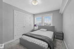 Bedroom featuring light carpet and a closet - 