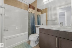 Bathroom with vanity and shower / tub combo with curtain - 