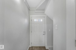 Doorway to outside featuring wood finished floors and baseboards - 