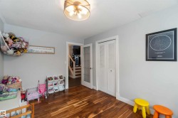 Playroom with dark wood-style flooring and a textured ceiling - 