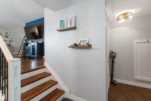Staircase with wood finished floors and a textured ceiling - 6 Garraway Pl, St. Albert, AB - Indoor Photo Showing Other Room