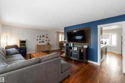 Living area with hardwood / wood-style flooring and baseboards - 