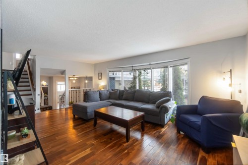 Living room with wood-type flooring and a textured ceiling - 6 Garraway Pl, St. Albert, AB - Indoor Photo Showing Living Room