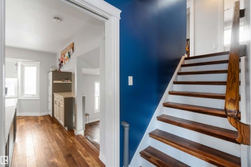 Stairway with wood finished floors and baseboards - 6 Garraway Pl, St. Albert, AB - Indoor Photo Showing Other Room