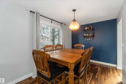 Dining room with dark wood-type flooring and baseboards - 