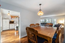 Dining room featuring light wood-style flooring and baseboards - 