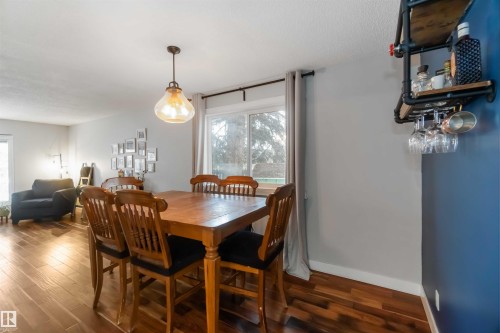 Dining area with dark wood-style flooring and a textured ceiling - 6 Garraway Pl, St. Albert, AB - Indoor Photo Showing Dining Room