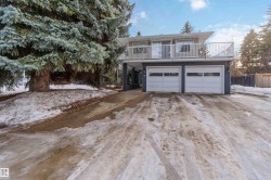 View of front of property featuring driveway and a garage - 
