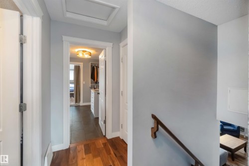 Hallway featuring an upstairs landing, dark wood-type flooring, and a textured ceiling - 6 Garraway Pl, St. Albert, AB - Indoor Photo Showing Other Room
