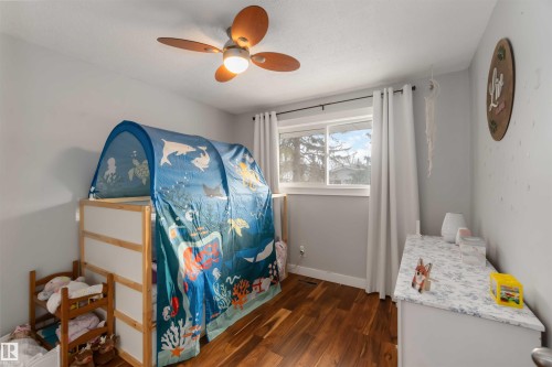 Bedroom featuring dark wood-type flooring and ceiling fan - 6 Garraway Pl, St. Albert, AB - Indoor