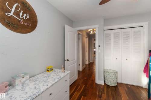 Bedroom featuring dark wood-type flooring, a closet, and a ceiling fan - 6 Garraway Pl, St. Albert, AB - Indoor Photo Showing Other Room