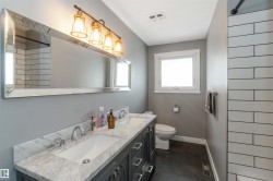 Full bathroom with double vanity and a shower - 