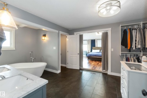 Full bath featuring double vanity, a freestanding bath, and ensuite bathroom - 6 Garraway Pl, St. Albert, AB - Indoor Photo Showing Bathroom