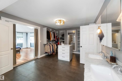 Walk in closet featuring a sink and dark tile patterned floors - 6 Garraway Pl, St. Albert, AB - Indoor