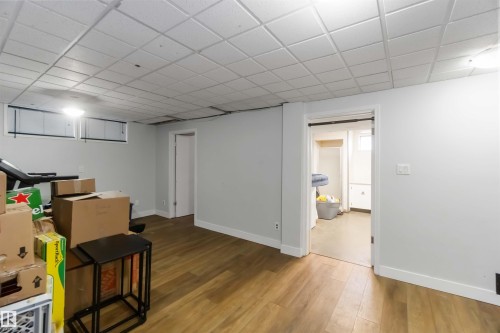 Finished basement with wood finished floors and a drop ceiling - 6 Garraway Pl, St. Albert, AB - Indoor Photo Showing Other Room