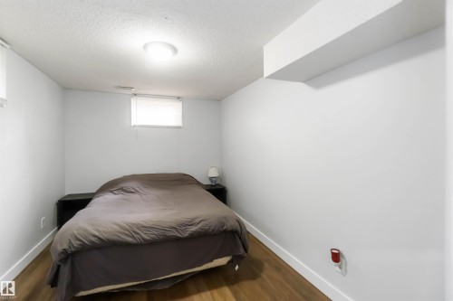 Bedroom featuring wood finished floors and a textured ceiling - 6 Garraway Pl, St. Albert, AB - Indoor Photo Showing Bedroom
